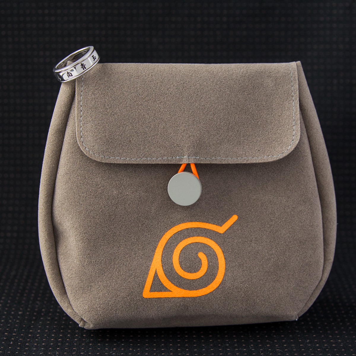 Lifestyle perspective of the Akatsuki spinner ring displayed with its suede collector pouch