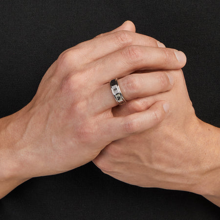 Close-up detail of the Akatsuki spinner ring highlighting the engraved cloud motifs and silver finish